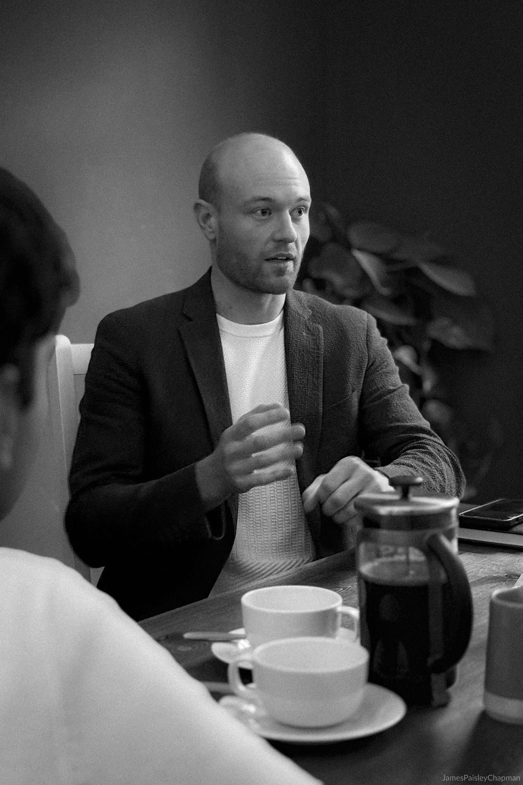 Tom, founder of Longtable, at a wooden desk by a window